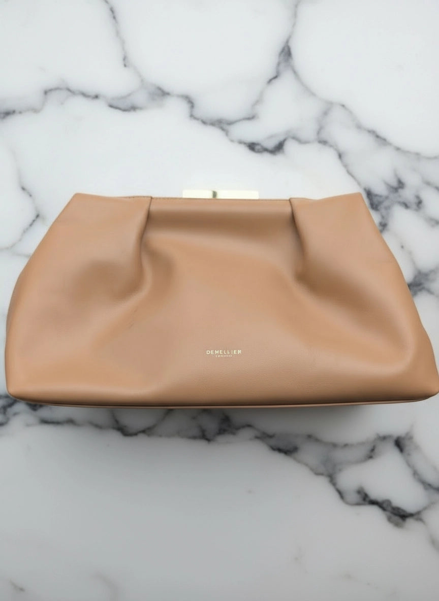 Broochella The Stylist's Closet DeMellier designer brown leather bag. Pictured on a white marble surface