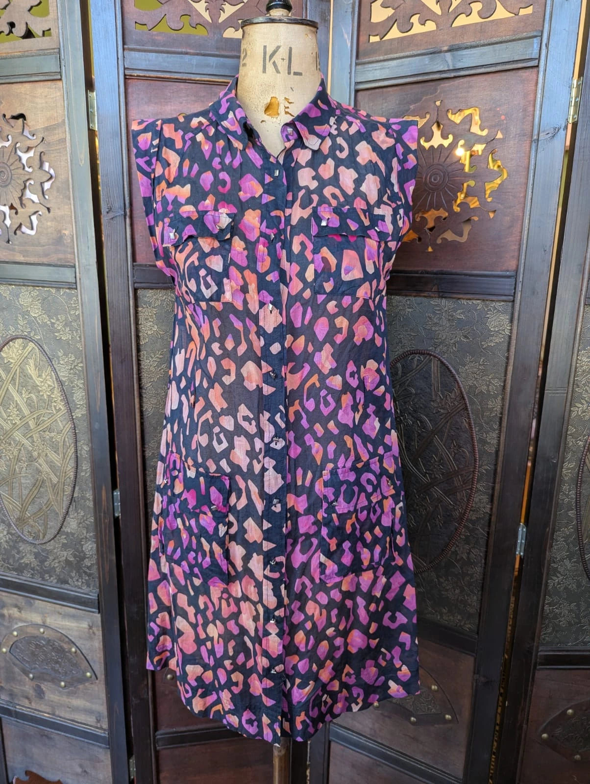Broochella The Stylist's Closet Matthew Williamson designer black, purple and pink cotton leopard print dress on a mannequin against a decorative wall.
