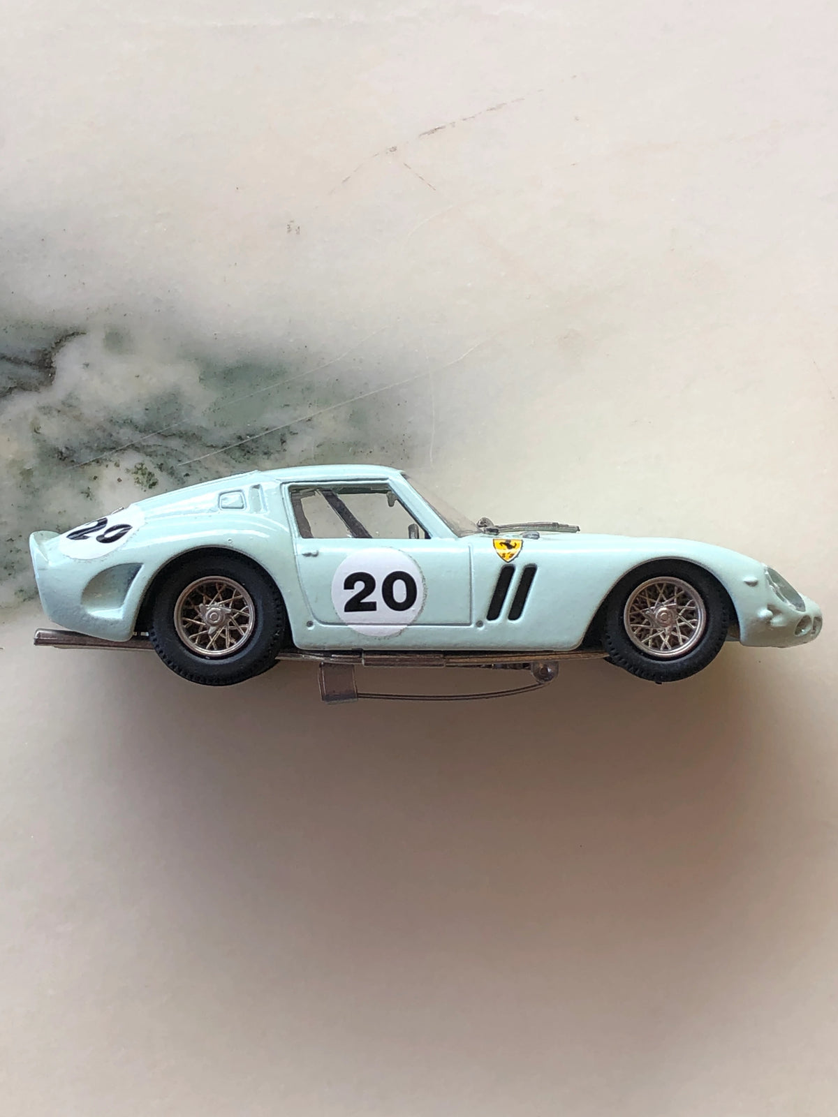 Broochella Men's Verde Acqua No.20 Vintage Ferrari Racing Car Brooch in side profile, featuring a pale aqua green coupe body, number 20 racing roundel, Ferrari shield, silver wire-spoke wheels, side air vents and visible metal brooch pin fastening.