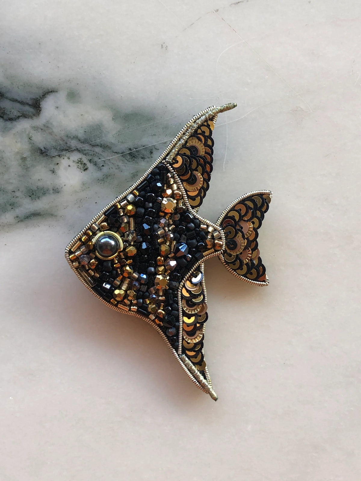 Broochella Pesciolino Fish Brooch featuring intricate black and gold hand-beading, metallic sequins and faceted bead embellishments.