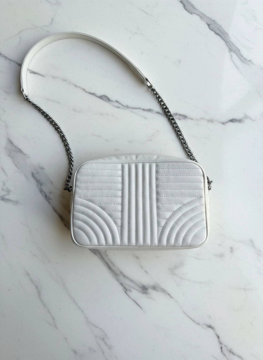 Broochella White authentic leather Prada designer camera bag purse on a white marble background