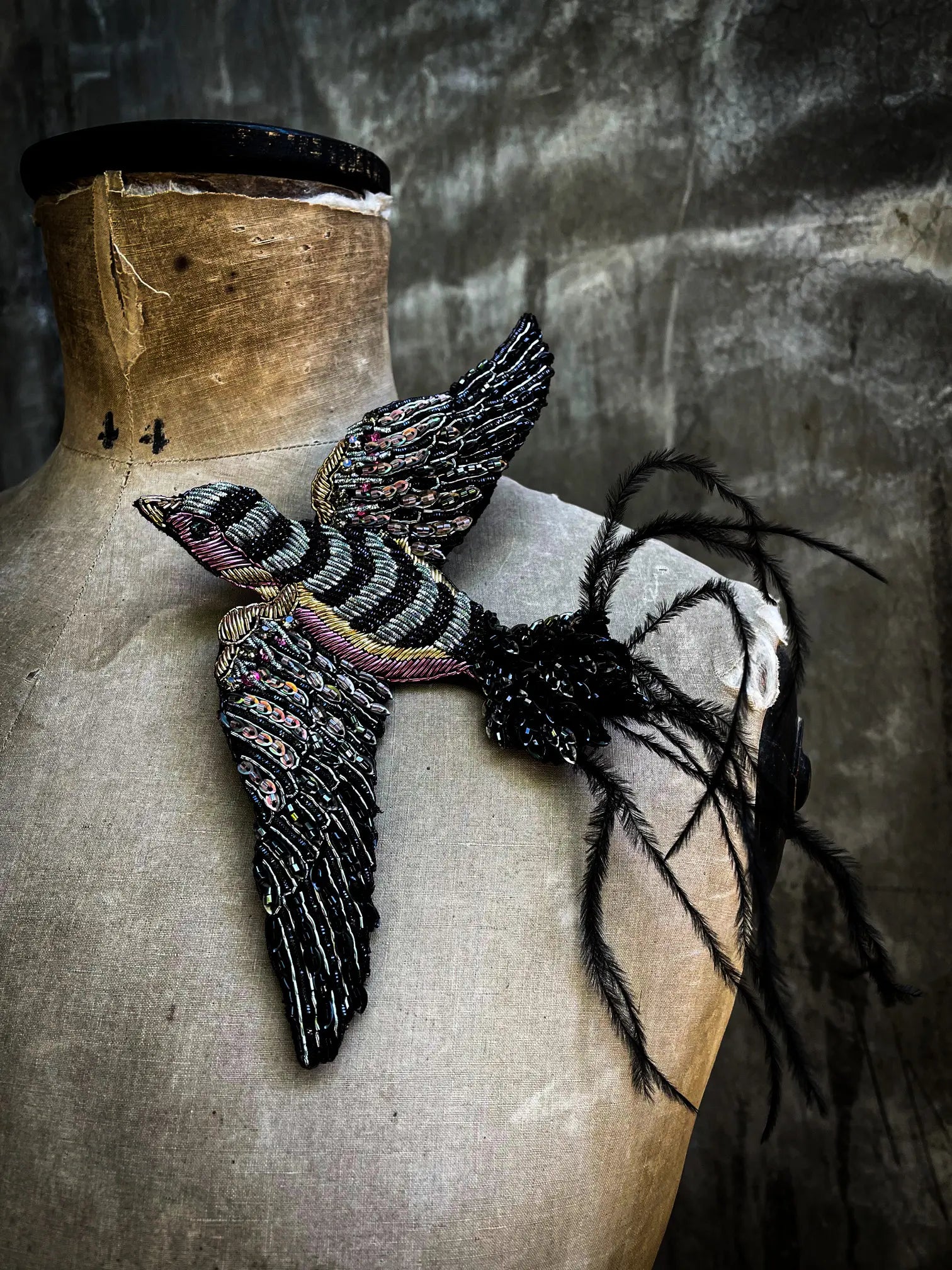 Broochella Rondine handmade hand beaded pink and black figural bird brooch. Styled on a mannequin. 