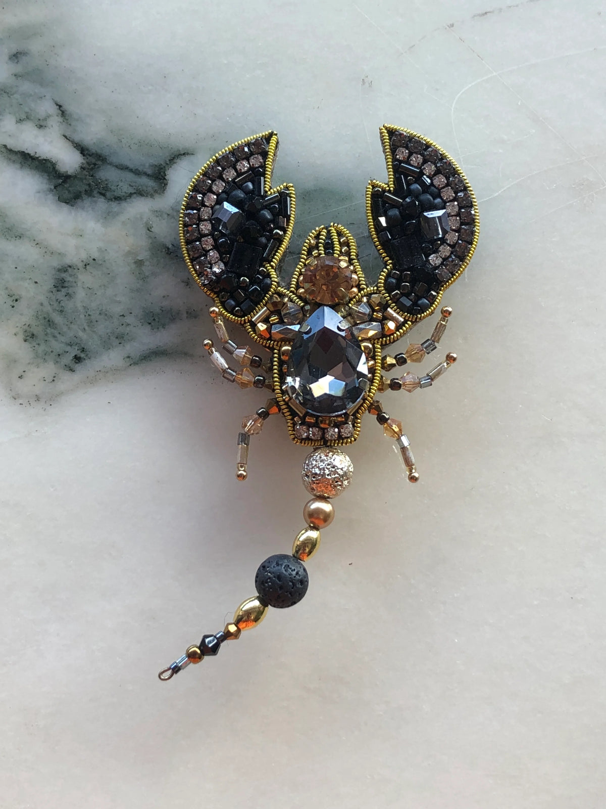 Broochella Scorpion Brooch Pin hand-beaded in black, gold and bronze with faceted crystals, rhinestones and a beaded articulated tail.