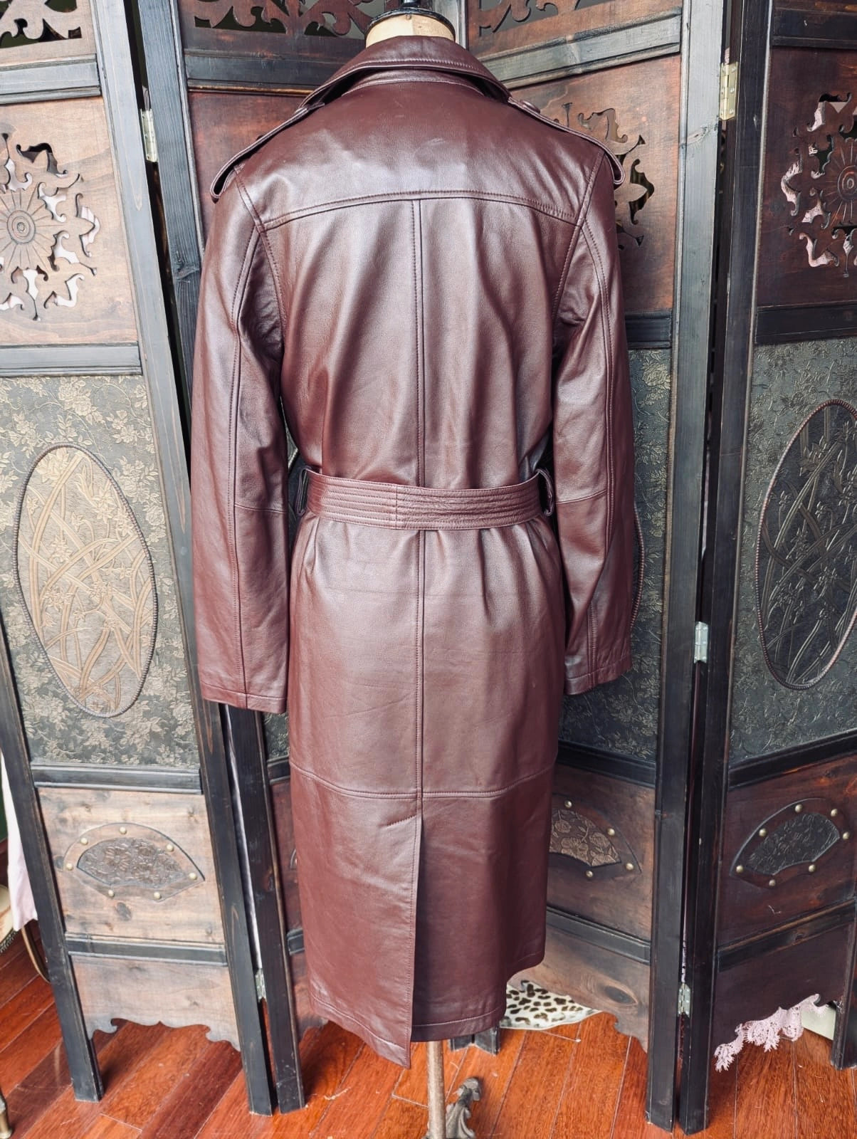 Broochella The Stylist's Closet Victoria and Woods Burgundy leather trench coat on a mannequin against an ornate wooden background